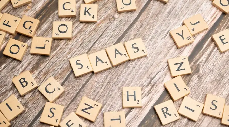 Wooden letter tiles spelling SaaS on rustic wood. Ideal for cloud computing and business concepts.