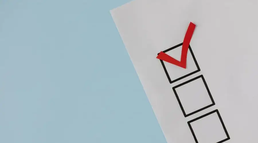 A simple white paper checklist with one red checkmark, ideal for concepts like completion or approval.
