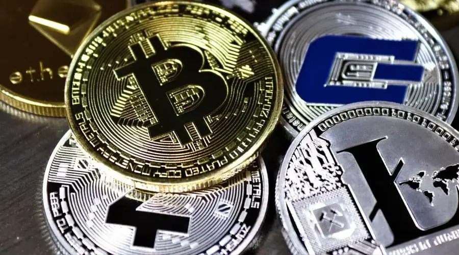 Close-up view of assorted cryptocurrency coins featuring Bitcoin, Litecoin, and others, symbolizing digital finance.