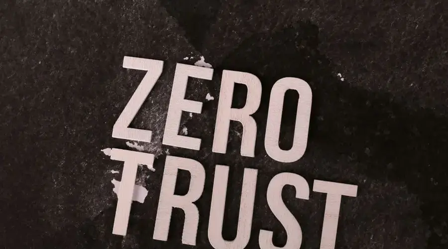 Bold 'Zero Trust' text against a textured black background, symbolizing cybersecurity.