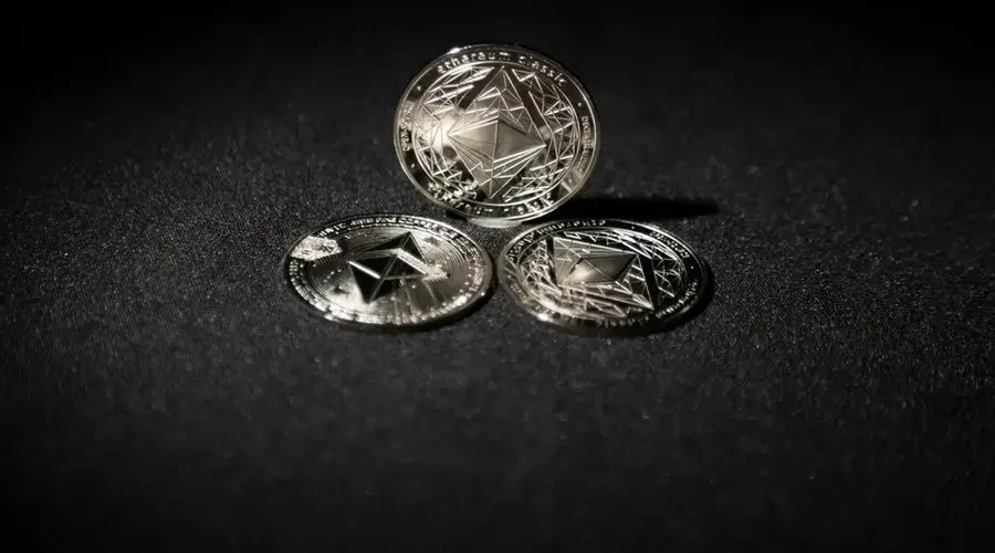 Close-up of three Ethereum coins on a dark background, showcasing digital currency themes.