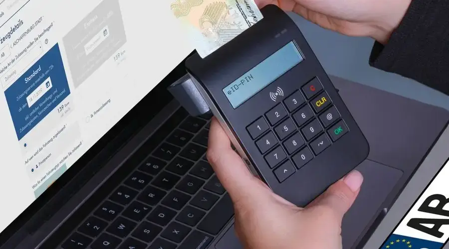 Close-up of a contactless payment using a card reader and laptop, highlighting digital security.