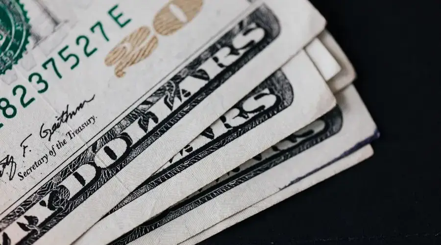 Closeup of USA 20 dollar banknotes placed on black background as national currency for business and personal financial operations