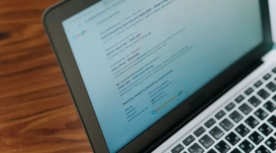 A close-up view of a laptop displaying a search engine page.