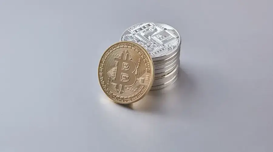 Stack of Bitcoin and cryptocurrency coins representing digital currency and financial wealth.