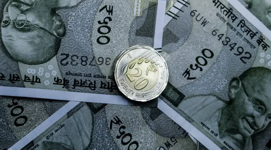 Detailed close-up of Indian 500-rupee notes and a 20-rupee coin, highlighting currency details.