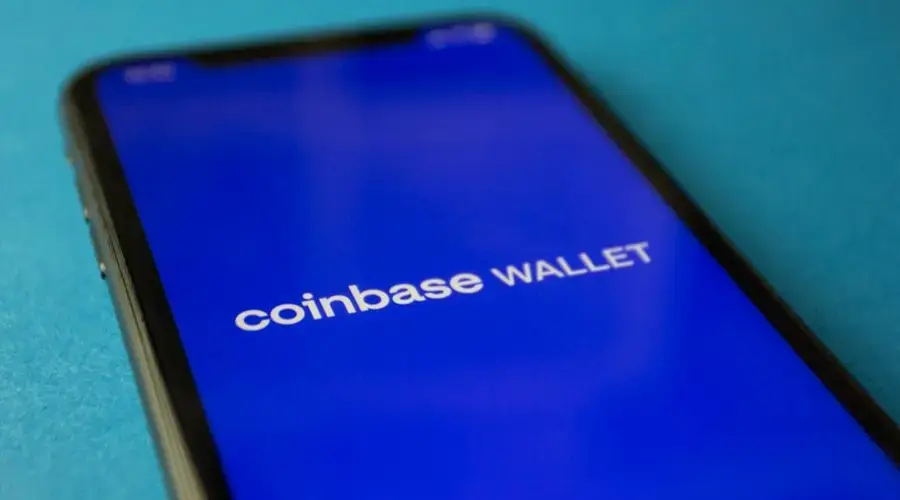 Close-up of a smartphone showing the Coinbase Wallet app interface for cryptocurrency transactions.