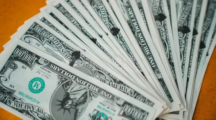 Closeup of novelty one million dollar bills laid out in a fan arrangement.
