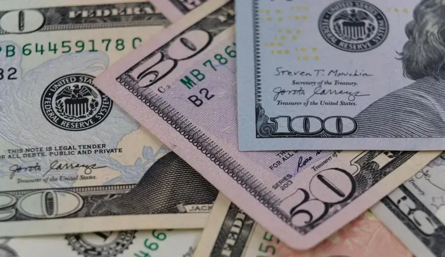 Detailed view of US currency, including $50 and $100 bills, symbolizing finance and economy.