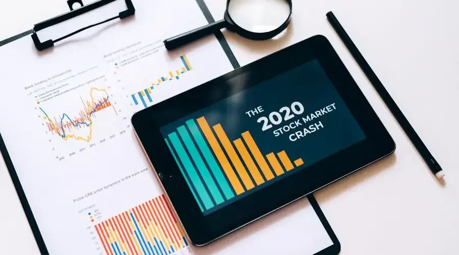 Close-up of financial graphs and digital tablet highlighting 2020 stock market crash.