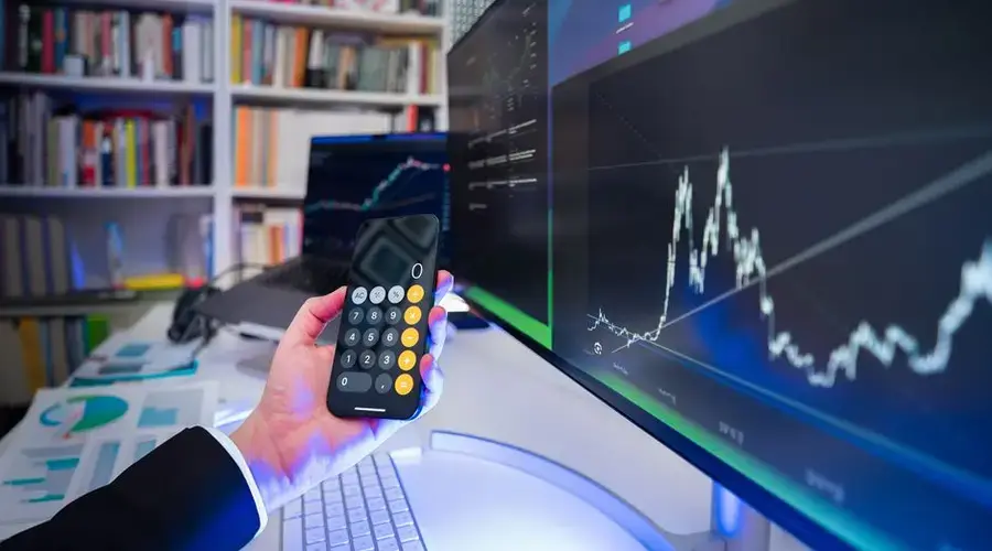 A modern office desk setup with financial analysis tools, highlighting technology in business strategy.