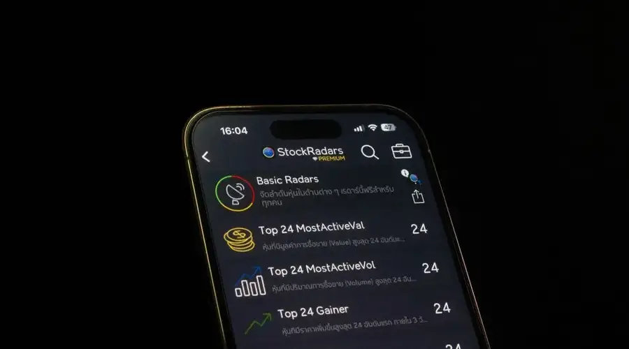 Close-up of a smartphone displaying a stock trading app interface, emphasizing financial analysis and investment insights.