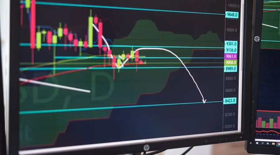 Close-up of a cryptocurrency trading chart displayed on a monitor, showing market trends and analysis.