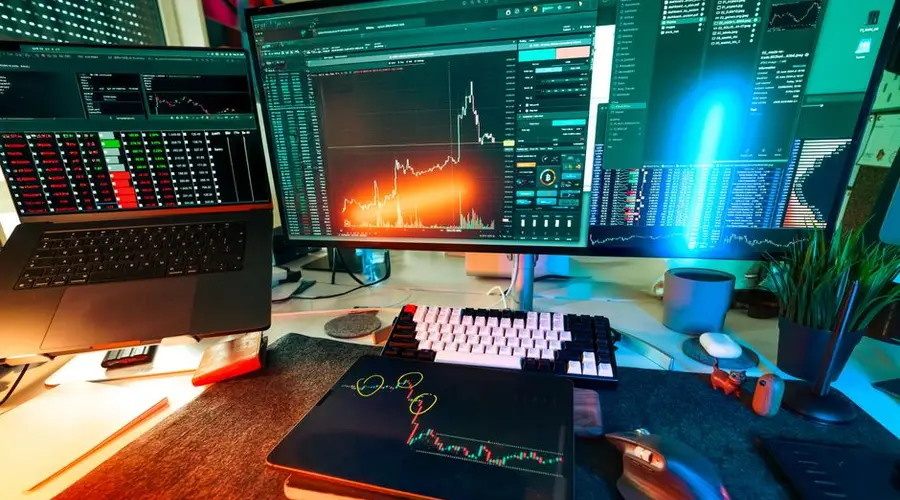 Vibrant trading setup with multiple screens displaying cryptocurrency charts and data analysis tools.