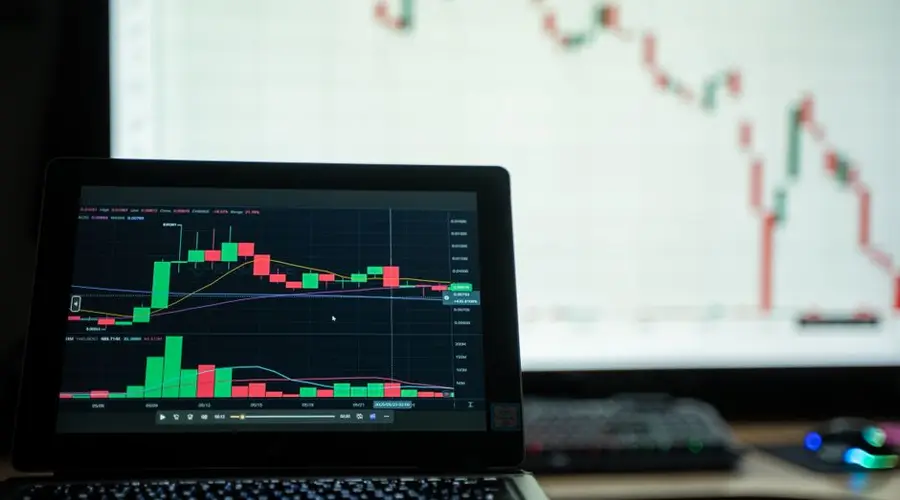 Close-up of a laptop showing cryptocurrency market charts in a trading environment.