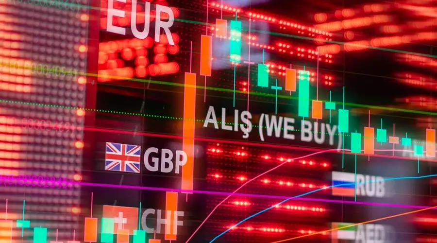 Dynamic forex trading concept with currency symbols and candlestick chart illuminated on screen.