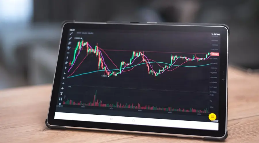 Close-up of a tablet showing financial graphs and trends. Ideal for finance and technology themes.