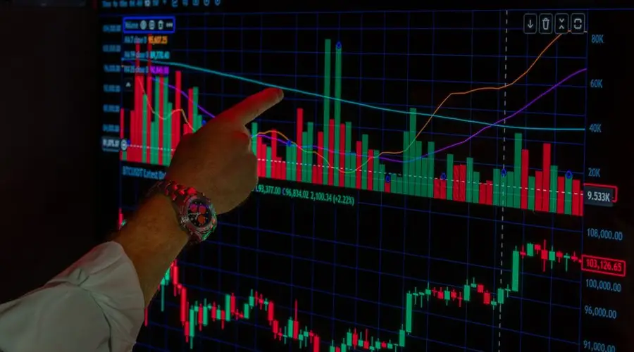 Close-up of a person analyzing Bitcoin market trends on a digital trading platform screen.
