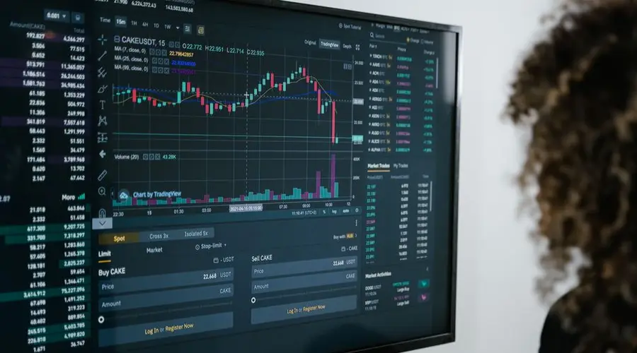 Detailed view of a financial analysis chart on a monitor with cryptocurrency trading data.