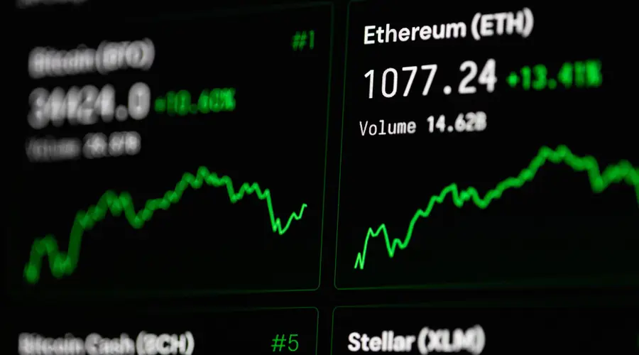 Close-up of cryptocurrency market data with Ethereum and Bitcoin prices on screen.