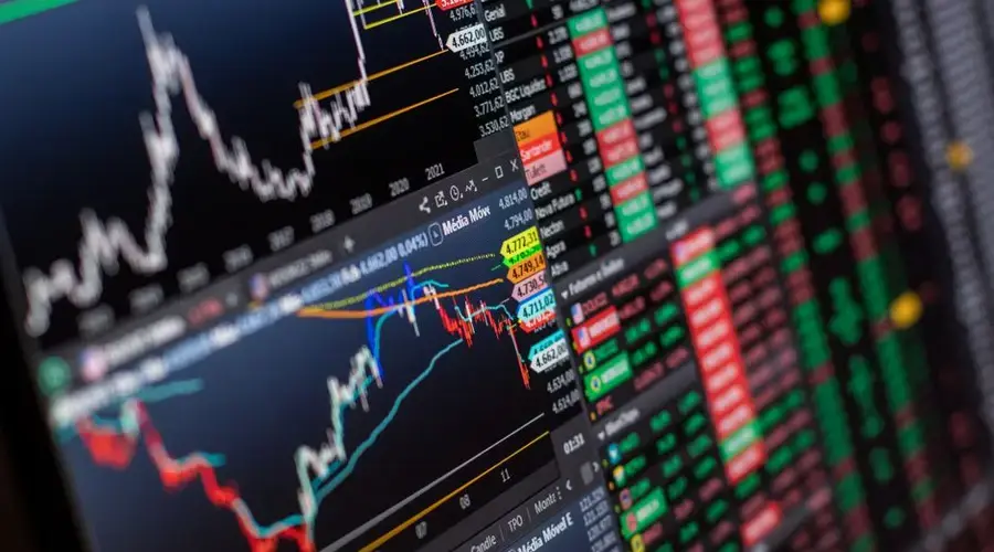 Detailed view of stock market charts and data on a monitor, showcasing market trends.