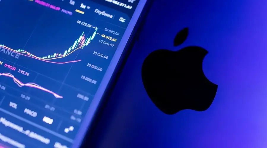 A close-up of an Apple device displaying stock market graphs, indicating economic trends.