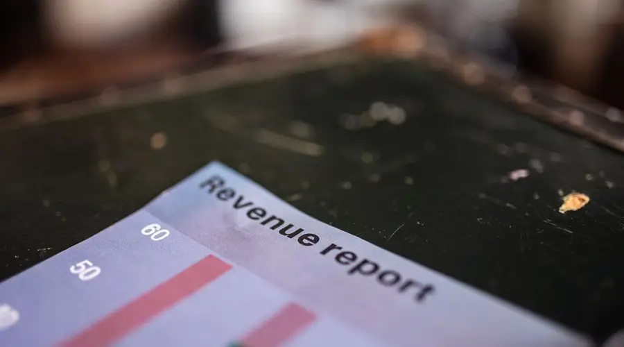 Detailed view of a revenue report featuring a bar chart in an office setting.