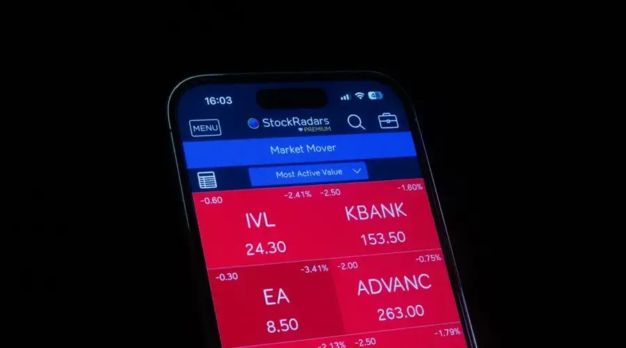 Close-up of a smartphone displaying a stock market app showing red losses.