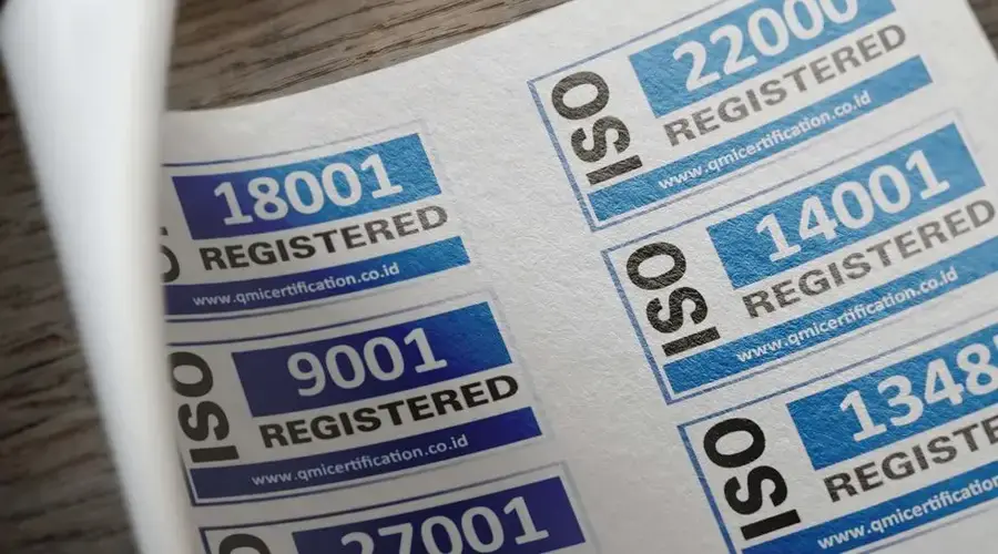 ISO certification stickers with registration numbers on paper.