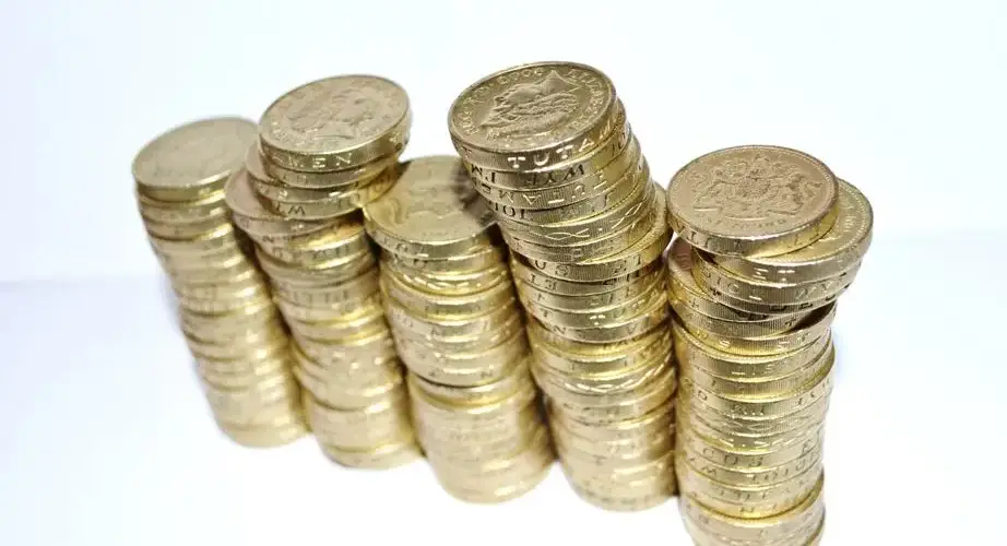 Close-up of stacked gold coins symbolizing wealth and financial growth.