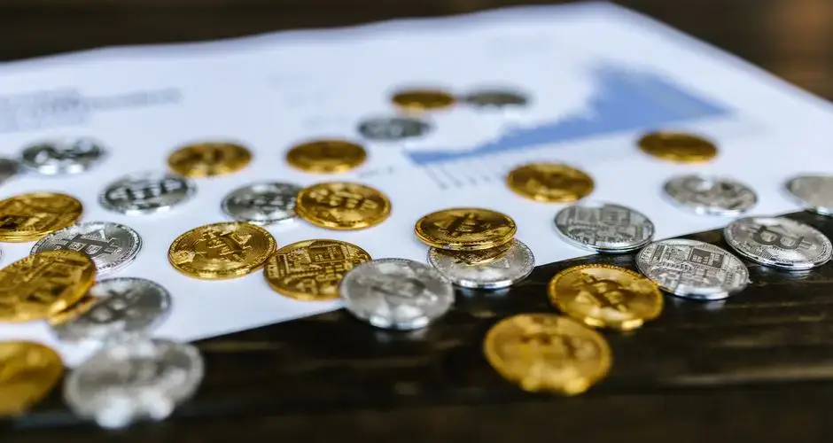 Digital currency coins on a paper chart, showcasing financial growth insights.