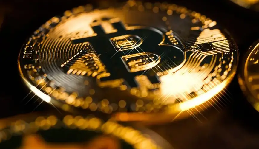 Close-up of golden Bitcoin coins representing digital cryptocurrency and finance.