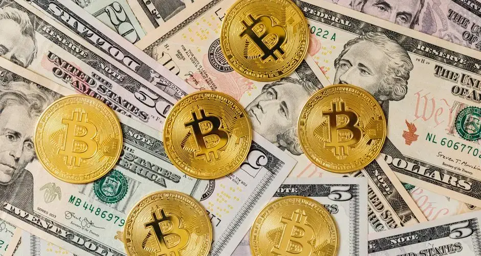 Gold bitcoins placed on a background of US dollar bills representing cryptocurrency and traditional finance.