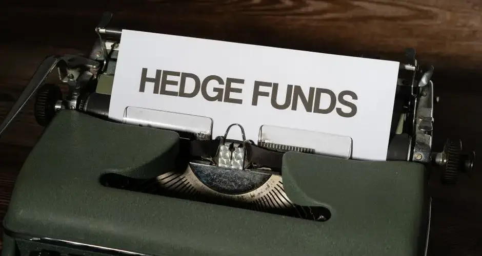 Close-up of a vintage typewriter with a paper labeled 'Hedge Funds'.