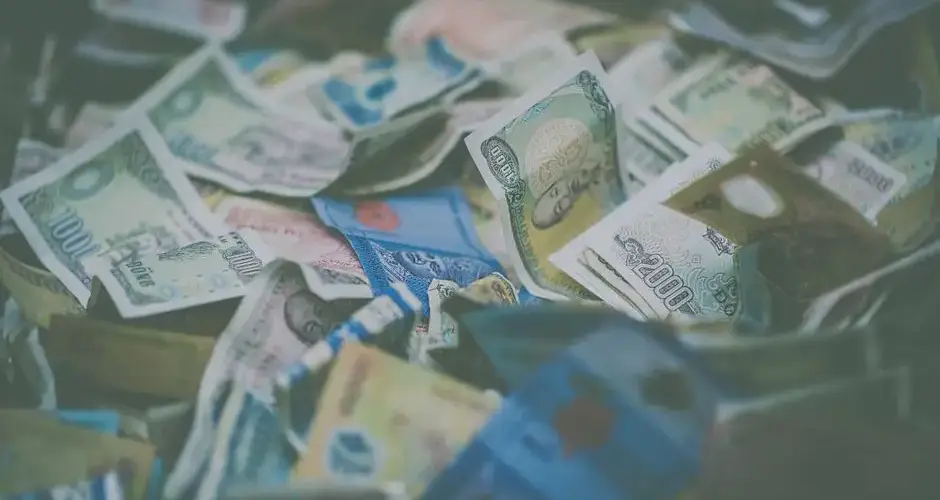 A close-up view of diverse international currency banknotes in soft focus, conveying wealth and finance themes.