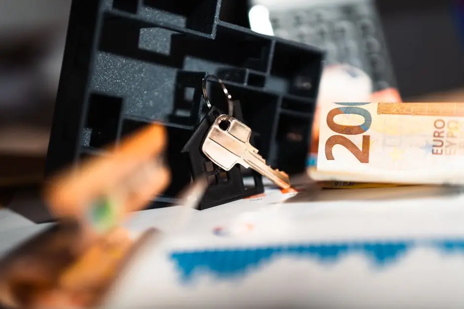 Keys with a house model, Euro bills, and charts suggesting real estate and financial themes.
