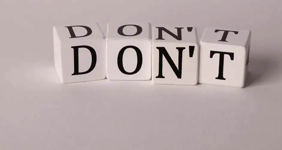 Text cubes spelling 'DON'T' on a clean white background, ideal for concepts of caution or prohibition.