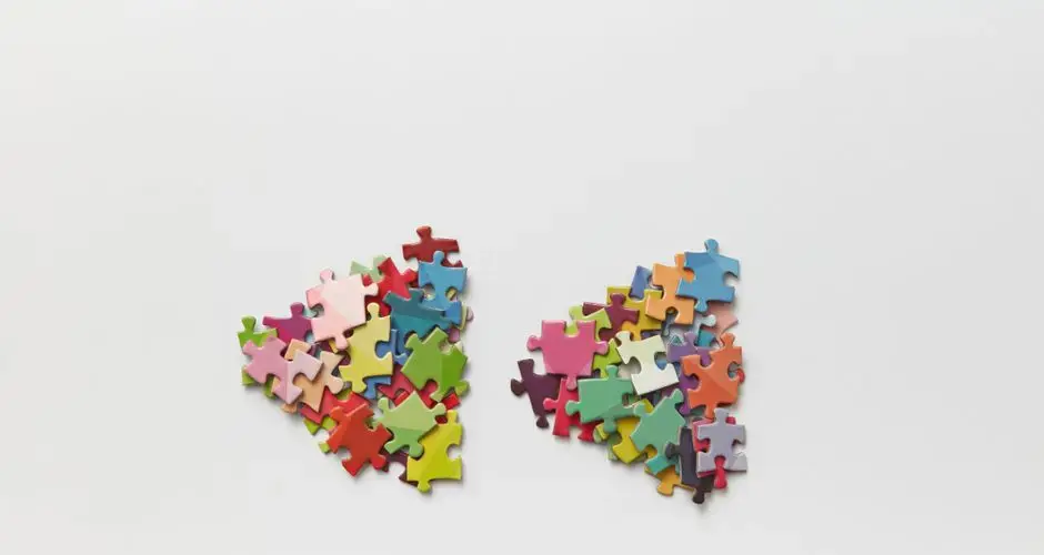 Brightly colored puzzle pieces arranged on a white surface, ideal for creative projects.