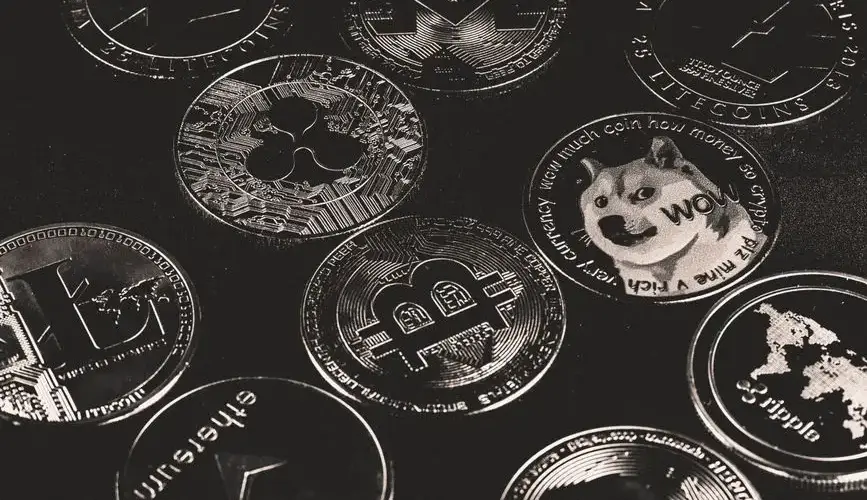 A collection of various cryptocurrency coins including Bitcoin, Ethereum, and Dogecoin.