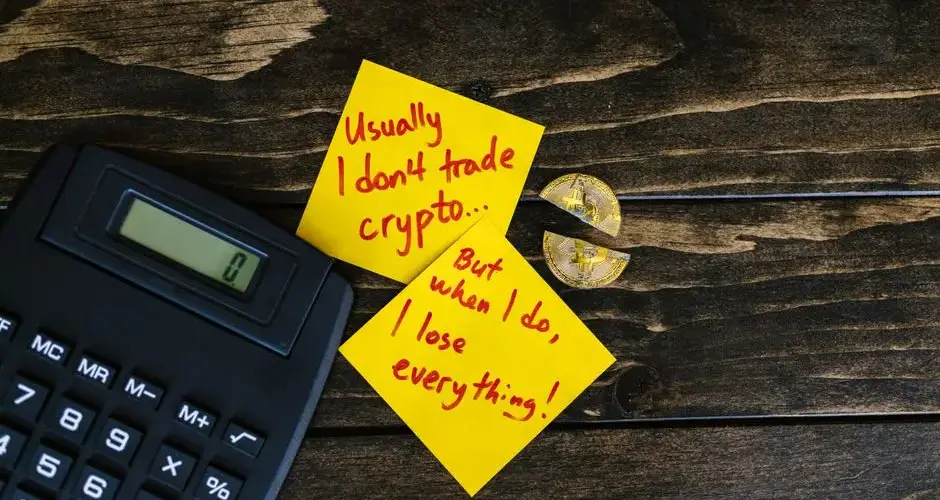 A satirical still life image depicting crypto investment risks with sticky notes, calculator, and broken coin.