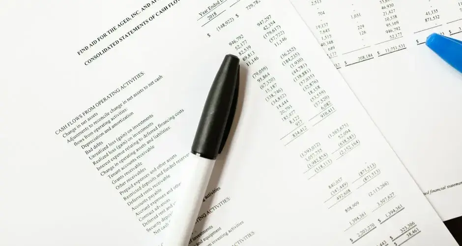 Financial documents featuring cash flows and pens, ideal for business themes and analysis.