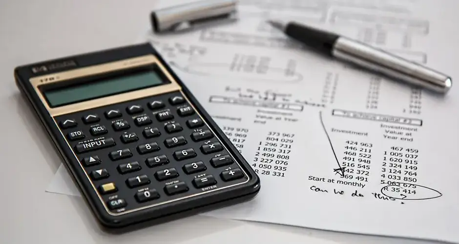 Close-up of financial documents with calculator and pen, ideal for business management themes.