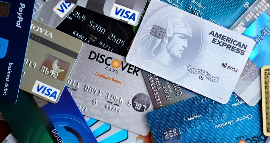 Close-up image of various credit cards including Visa, Mastercard, and American Express.