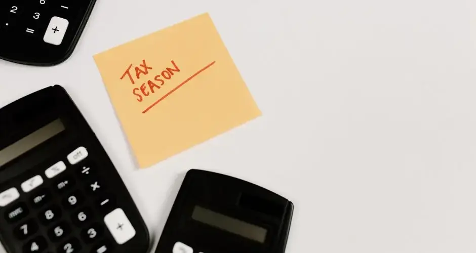 Calculators and sticky note labeled 'Tax Season' on white background, ideal for financial themes.