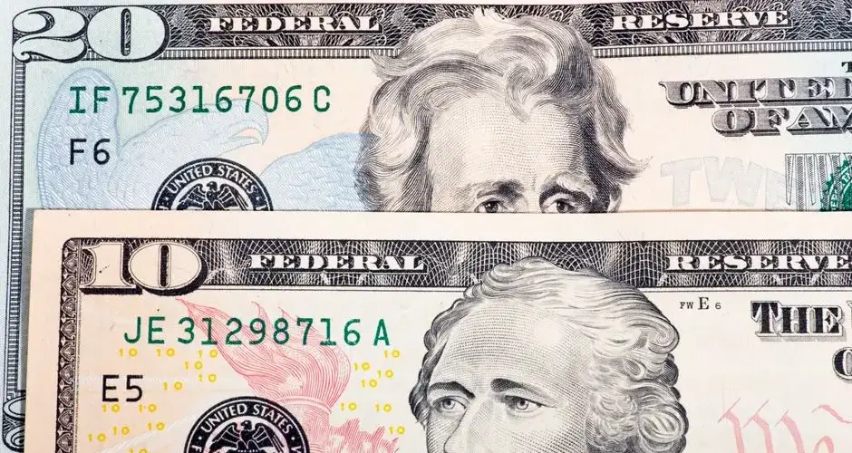 Detailed view of US ten and twenty dollar bills, highlighting design and texture.