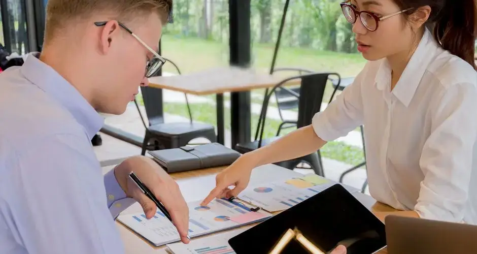 Team collaboration over financial documents in a modern office setting.
