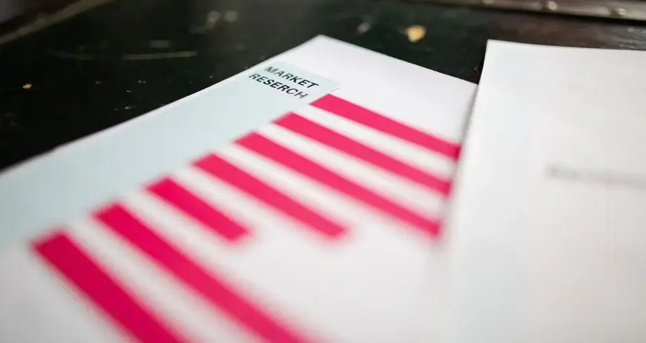 A detailed close-up of a market research document featuring a bar graph and a focus on market trends.