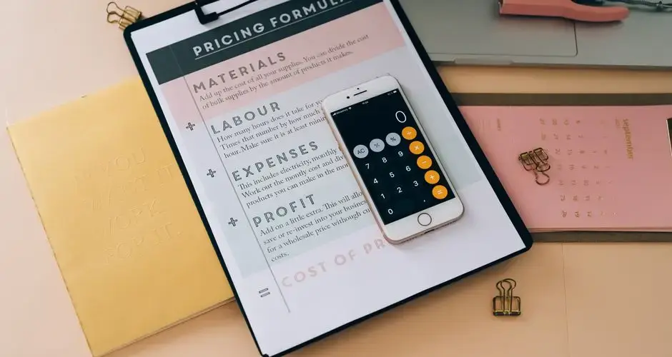 Organized business tools with a smartphone, documents, and stationery in a flat lay format.
