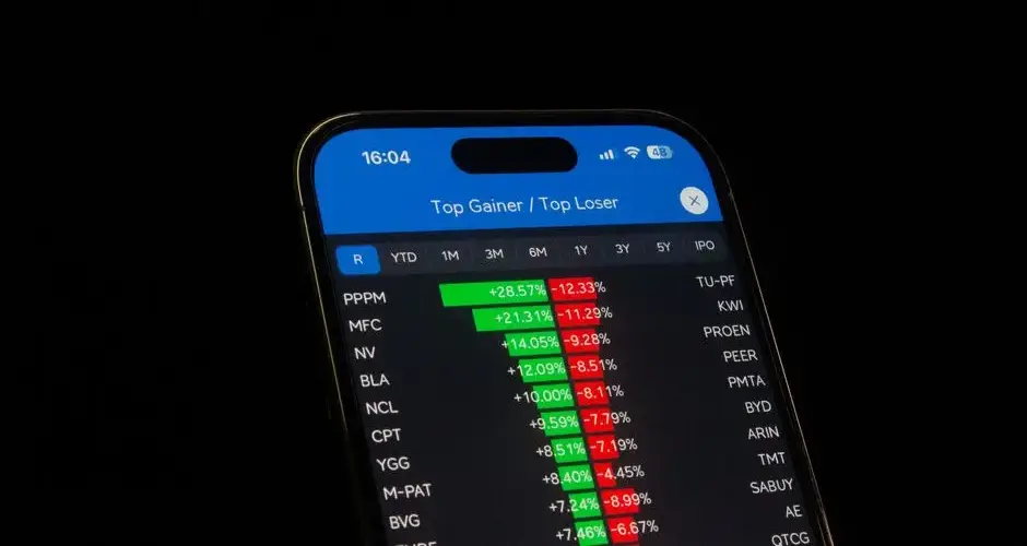 Close-up of a smartphone showing stock performance in a trading app. Ideal for financial and business themes.