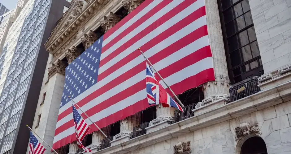 American flag on a historic building exterior symbolizing patriotism and national pride.